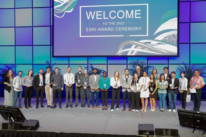 On-stage at the Special Achievement in GIS Award ceremony with my fellow Esri Young Scholars in attendance and Jack Dangermond